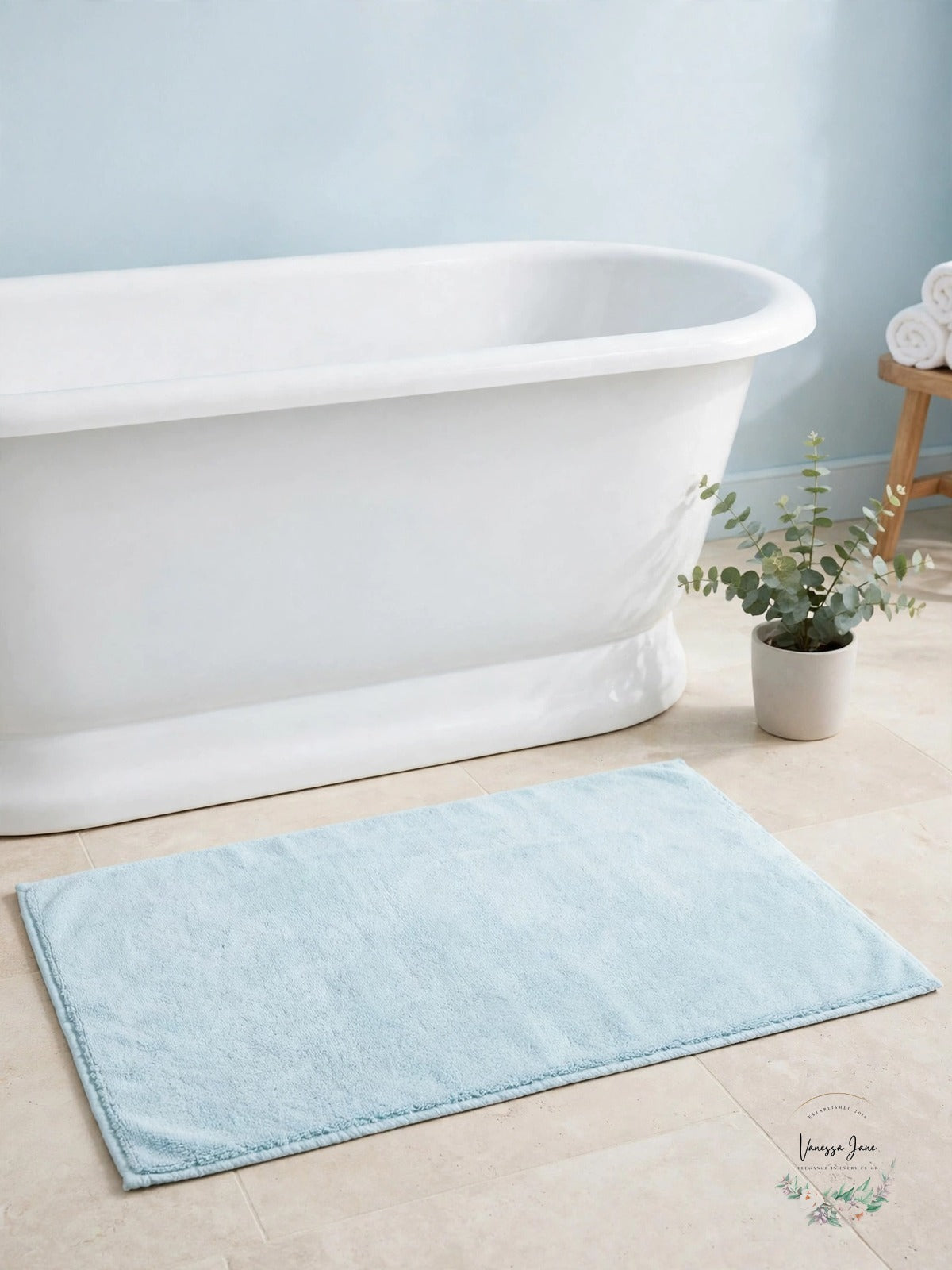 Wan blue tub mat in bathroom