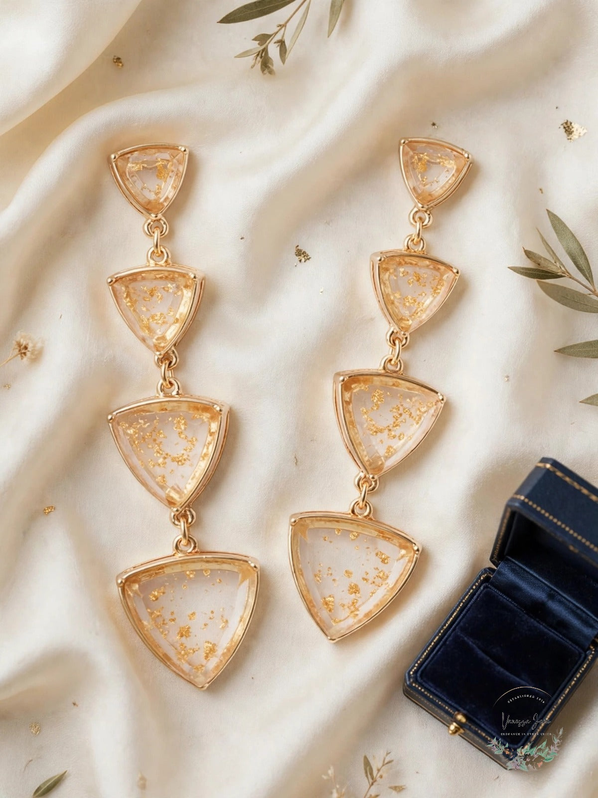 Guess triangle earrings flat lay