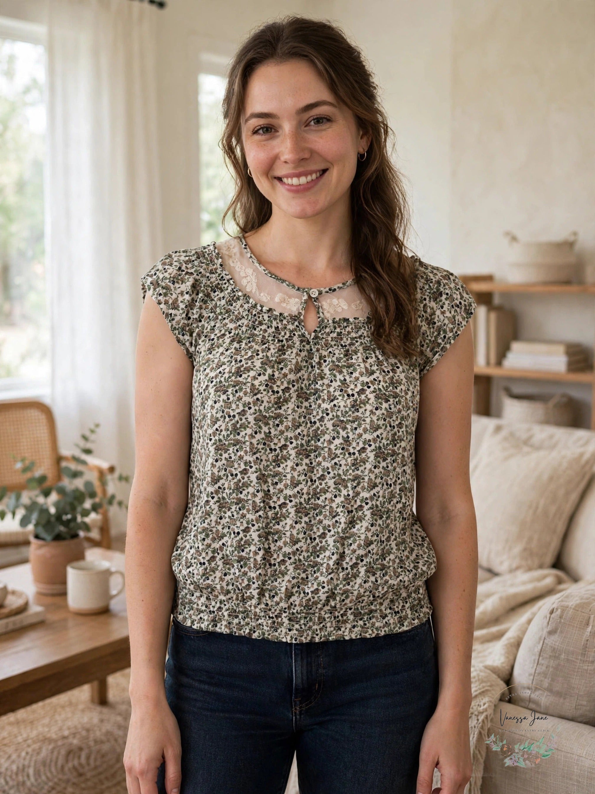 Nine West Mollie ivory floral lace yoke blouse worn by model in living room