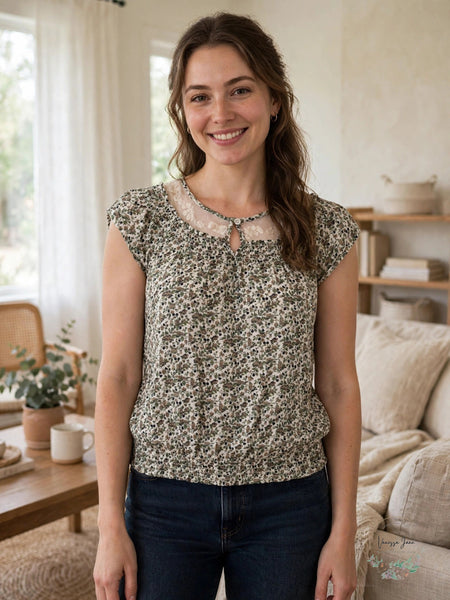 Nine West Mollie ivory floral lace yoke blouse worn by model in living room